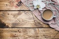 Orchid flower, cup of coffee and beads on a wooden table. Concept romance mood. Copy space and flat lay Royalty Free Stock Photo