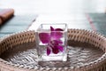 orchid flower in glass. Thai backrest pillow on mat. Thailand sc