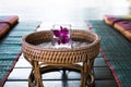 orchid flower in glass. Thai backrest pillow on mat. Thailand sc