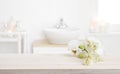 Orchid flowers on wooden table in blurred spa salon bathroom Royalty Free Stock Photo