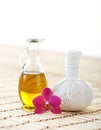 Orchid, jar with oil and massaging ball on a bamboo mat Royalty Free Stock Photo