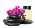 Orchid with spa stones and cosmetic on white Royalty Free Stock Photo