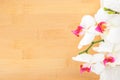 orchid and white towels on bamboo wooden background