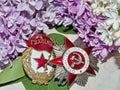 Order of the `Great patriotic war`, sign of `Guards` on the background of the blooming lilac. May 9 Victory Day