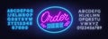 Order here neon sign on brick wall background. Royalty Free Stock Photo