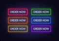 Order now neon sign on a brick background. Multicolored glowing buttons. Royalty Free Stock Photo