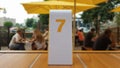 The order number on the table on the street in a McDonald`s restaurant. Awaiting an order at a McDonald`s restaurant. Fast food