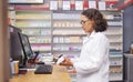 Order, pills and pharmacist scanning medicine at a checkout for service at a pharmacy. Healthcare, medical and woman on