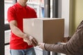 Order received. Woman receives big cardboard box from courier