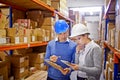 Order status On its way. a man and woman inspecting inventory in a large distribution warehouse. Royalty Free Stock Photo