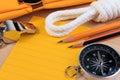 Orderliness white scout rope, scarf, whistle, compass, pencil and paper note. Royalty Free Stock Photo