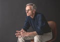 Orderly senior male sitting on chair Royalty Free Stock Photo