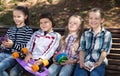 Ordinary children in the park on a bench in autumn Royalty Free Stock Photo