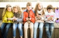 Ordinary children playing with the phone on bench outdoors Royalty Free Stock Photo