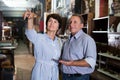 Ordinary couple is shopping in the antique store Royalty Free Stock Photo