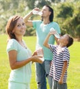 Ordinary couple with teenager drinking water