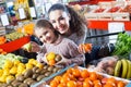 Ordinary family customers buying ripe fruits Royalty Free Stock Photo