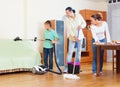 Ordinary family of three doing house cleaning Royalty Free Stock Photo