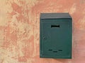 Green mailbox on the wall of an old house in the city Royalty Free Stock Photo