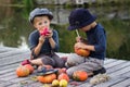 Ordinary kids paint small Halloween pumpkins