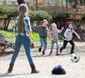 Ordinary kids playing street football outdoors