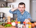 Man adding spice to the salad Royalty Free Stock Photo