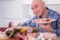 Man posing with a plate of cold cuts Royalty Free Stock Photo