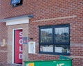 Ordinary new semi-detached house for sale and two recycling skips in front of it Royalty Free Stock Photo