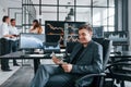 Ordinary office day. Team of stockbrokers works in indoors with many display screens