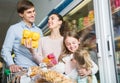 Ordinary parents with two kids holding purchases in store Royalty Free Stock Photo