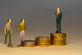 Ordinary people looking to business man standing on top of increasing piles of gold coins. Business career concept