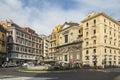 Ordinary people walking on Piazza Trieste E Trento, street view with facade of Galleria Umberto