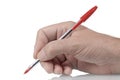 Hand writing or signing with red ballpoint pen, white background Royalty Free Stock Photo