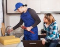 Ordinary repairman working at kitchen Royalty Free Stock Photo