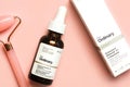 The Ordinary skincare brand. Closeup of The Ordinary retinoid serum Granactive retinoid in squalane and jade massanger roller for