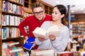 Ordinary student choosing book in library Royalty Free Stock Photo