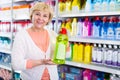 Ordinary woman choosing household chemical goods Royalty Free Stock Photo