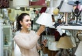 Ordinary woman doing shopping in lighting shop