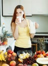 Ordinary woman drinking milk cocktail with fruits Royalty Free Stock Photo