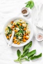 Orecchiette pasta with spinach and pumpkin - vegetarian lunch on white background Royalty Free Stock Photo