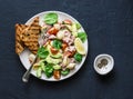 Orecchiette pasta, tuna, avocado, spinach, tomato salad and whole grain bread toast - healthy lunch on a dark background Royalty Free Stock Photo