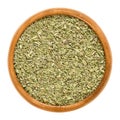 Oregano dried in wooden bowl over white