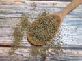 Oregano (Origanum vulgare) dried, dehydrated in a wooden spoon on an old wooden table, top view Royalty Free Stock Photo