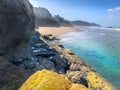 Cliff at Hug Point beach Oregon with teal blue ocean water Royalty Free Stock Photo