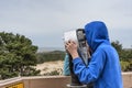Young Teen look through telescope on Oregon Coast