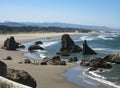 Wide shot of dramatic Oregon coastline under blue sky