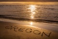 Oregon Coast sunset, text written on the beach