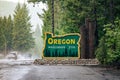 Oregon welcomes you sign at state line. US-HWY 199 Redwood Highway in rain Royalty Free Stock Photo