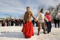 Orel, Russia - February 26, 2017: Maslenitsa fest. Girl in Russian dress leading roundelay in snow field
