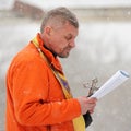 Orel, Russia - January 19, 2016: Russian epiphany feast. Orthodox priest blessing water in ice-hole Royalty Free Stock Photo